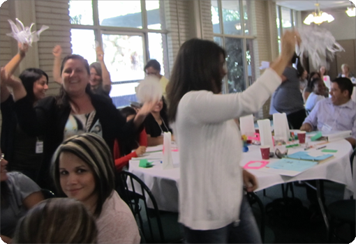 Group of adults cheering during a Teaching Pyramid activity